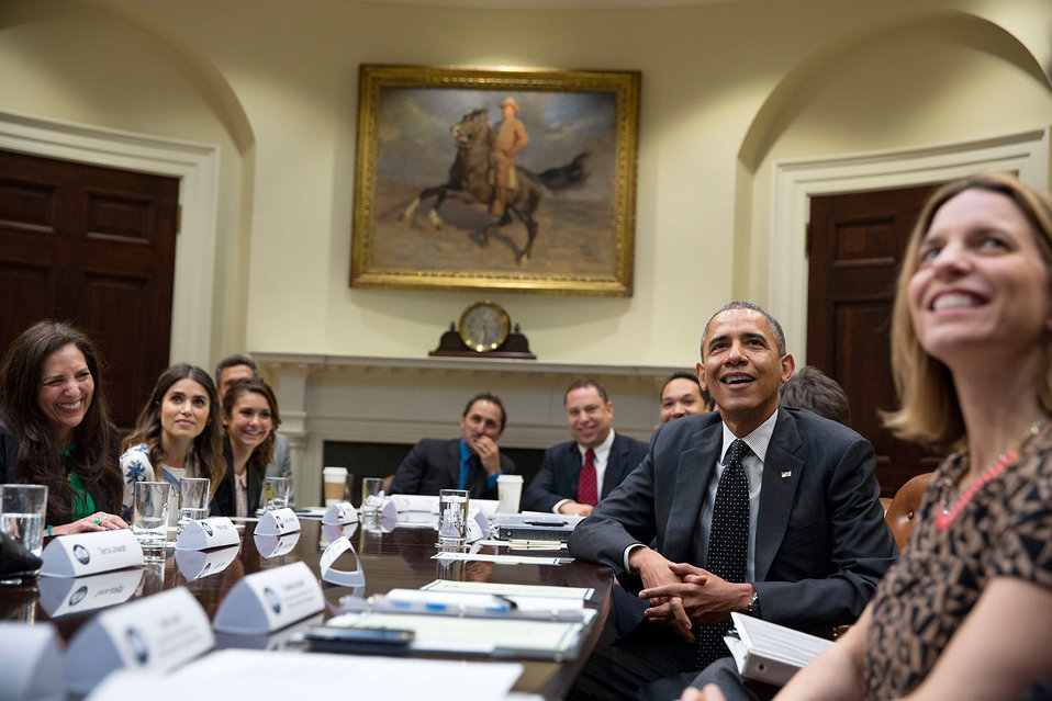 President Barack Obama watches a video during a drop by of an Affordable Care Act meeting in the Roosevelt Room of the White House, March 12, 2014. (Official White House Photo by Pete Souza)